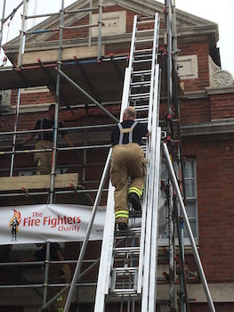Firefighters charity climb. Climbing the ladder