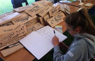 Signing roof shingles to raise funds